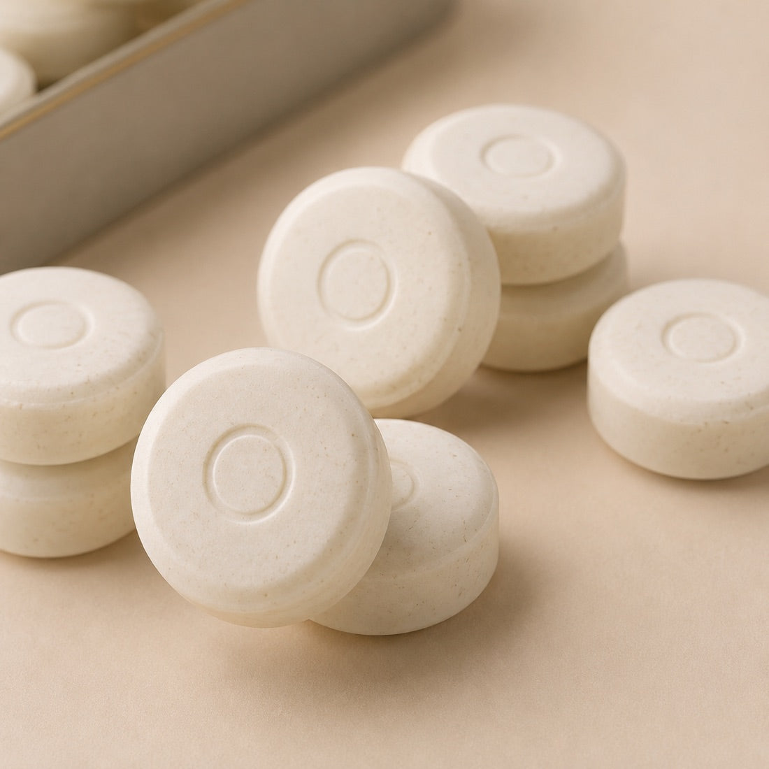 Macro view of Olven mints — matte compressed surface with an embossed O